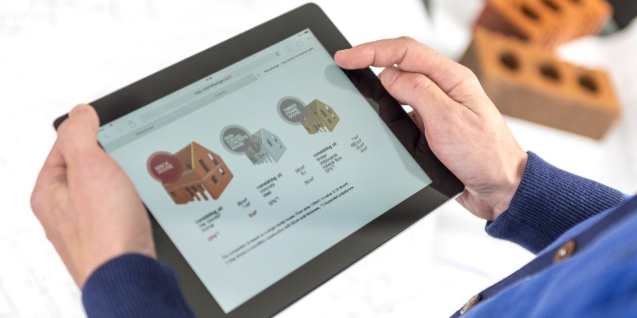 Hands holding tablet showing a comparison of building types
