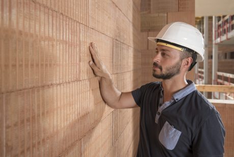 Building professional touching brick block wall